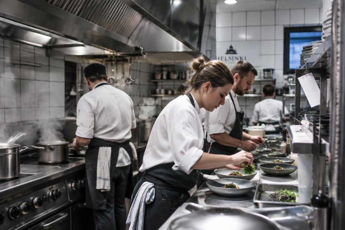 Cooks plating in a Helsinki restaurant kitchen.